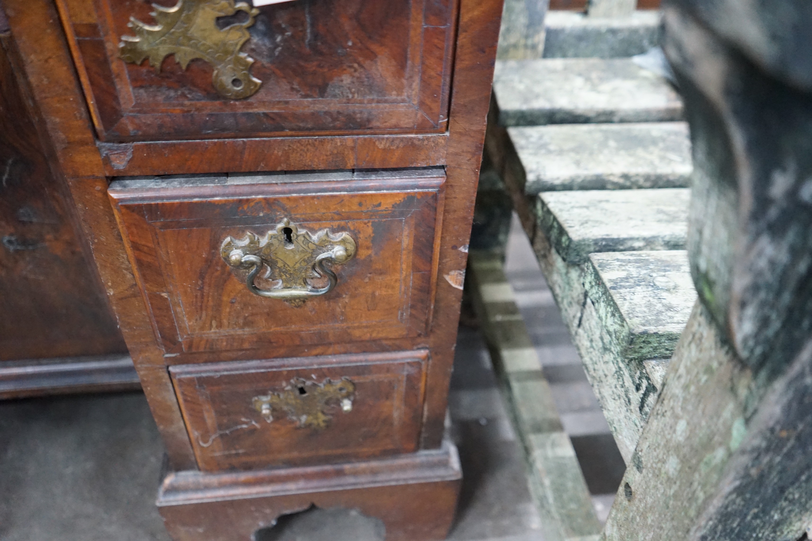 An 18th century feather banded walnut kneehole desk, width 81cms, depth 52cms, height 76cms.